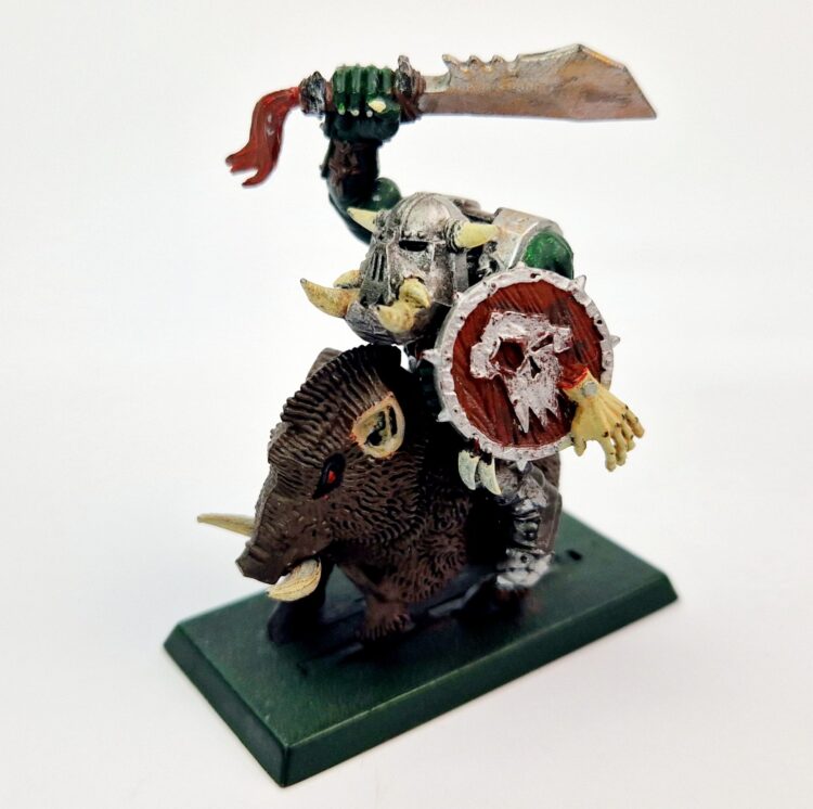 A photo of a Orcs and Goblins Orc Warboss on Boar Warhammer miniature