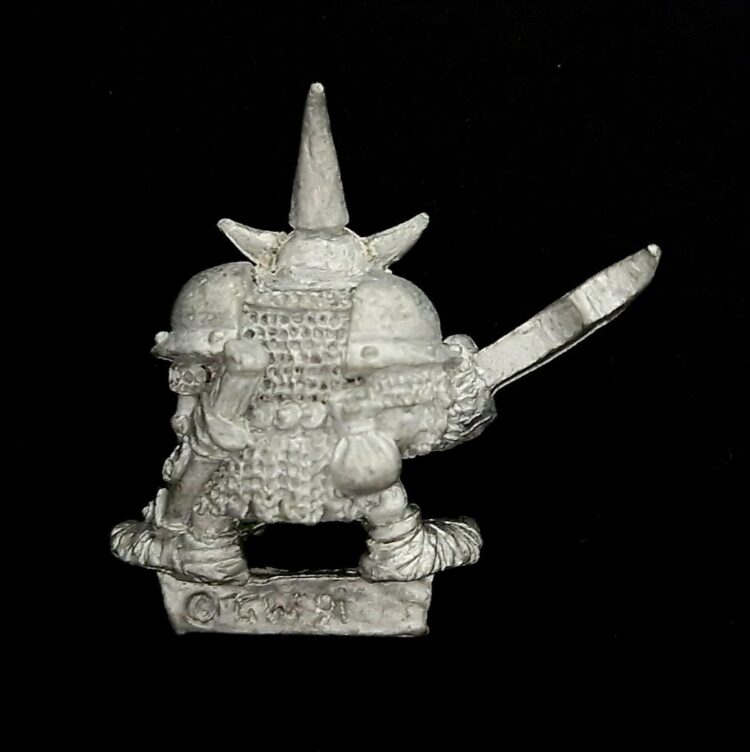 A photo of a Orcs and Goblins Night Goblin Champion Warhammer miniature