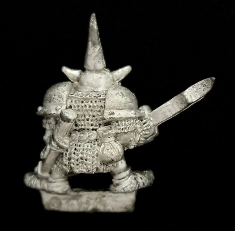 A photo of a Orcs and Goblins Night Goblin Champion Warhammer miniature