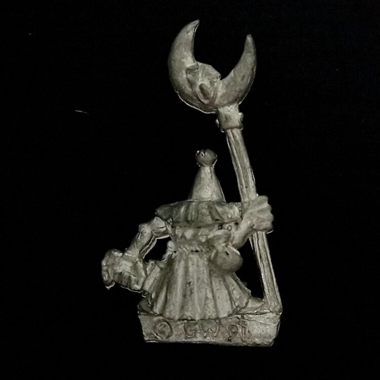 A photo of a Orcs and Goblins Night Goblin Standard Bearer Warhammer miniature