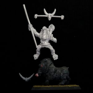 A photo of a Orcs and Goblins Savage Boar Boyz Standard Bearer Warhammer miniature