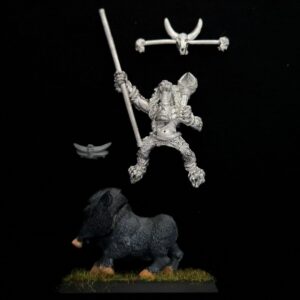 A photo of a Orcs and Goblins Savage Boar Boyz Standard Bearer Warhammer miniature