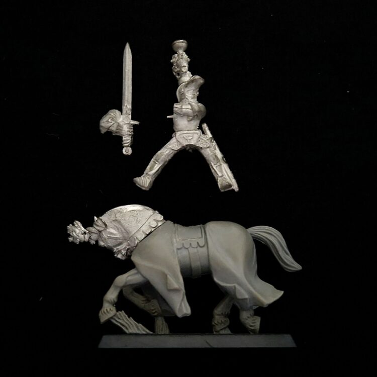 A photo of a Bretonnian Grail Knight Hero With Two Handed Sword Warhammer miniature