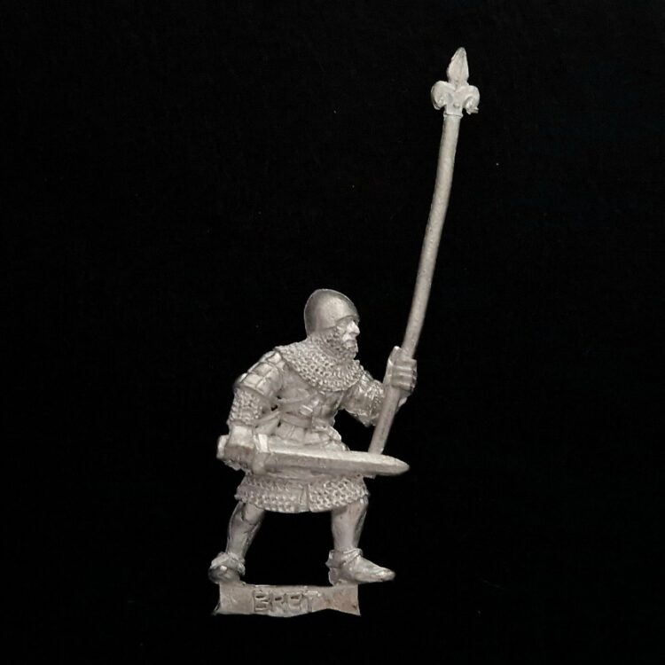 A photo of a Bretonnia Men at Arms Halbediers Standard Bearer Warhammer miniature