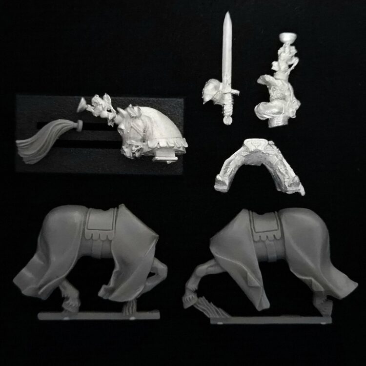 A photo of a Bretonnian Grail Knight Hero With Two Handed Sword Warhammer miniature