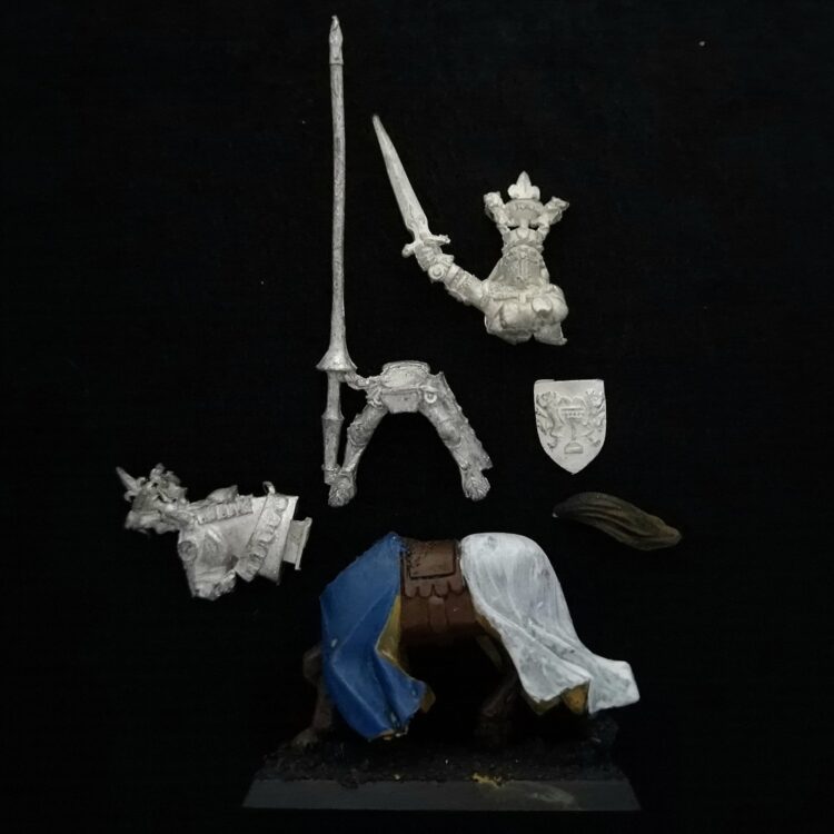 A photo of a Bretonnia Grail Knight Champion Warhammer miniature