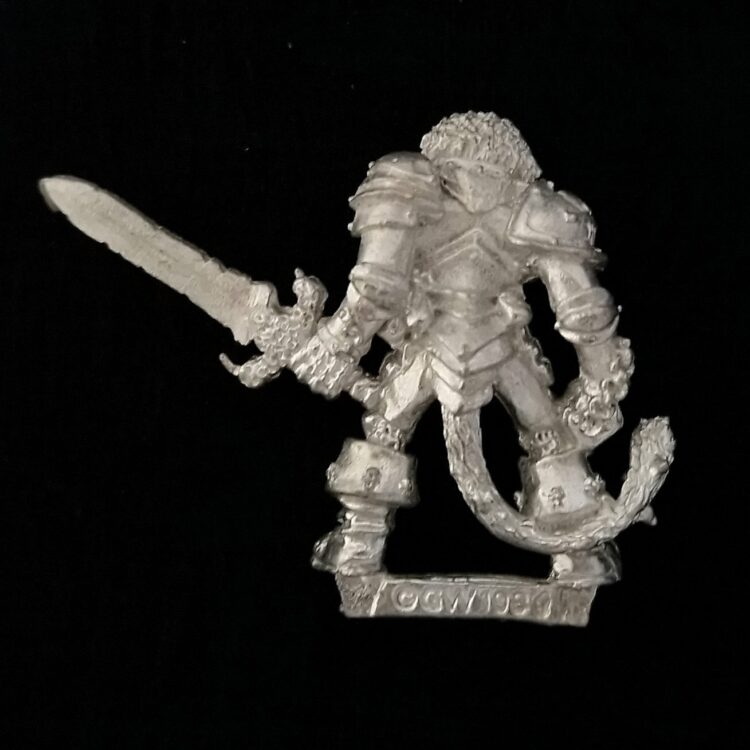 A photo of a Chaos Warriors Champion of Khorne Warhammer miniature