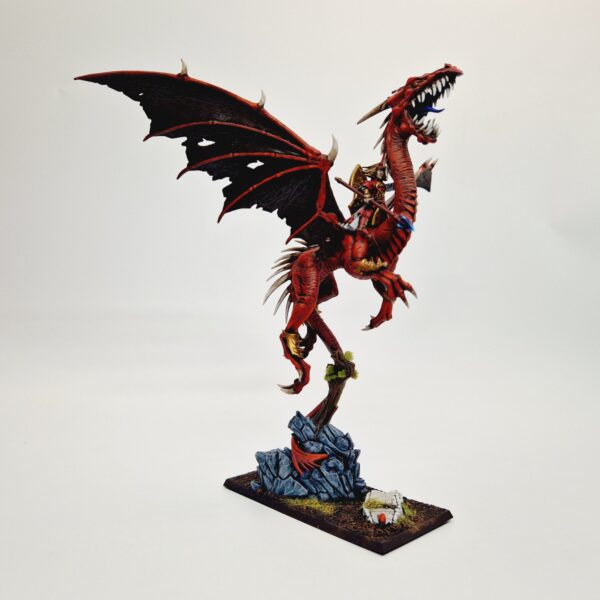 A photo of a High Elf Mage on Dragon Warhammer miniature