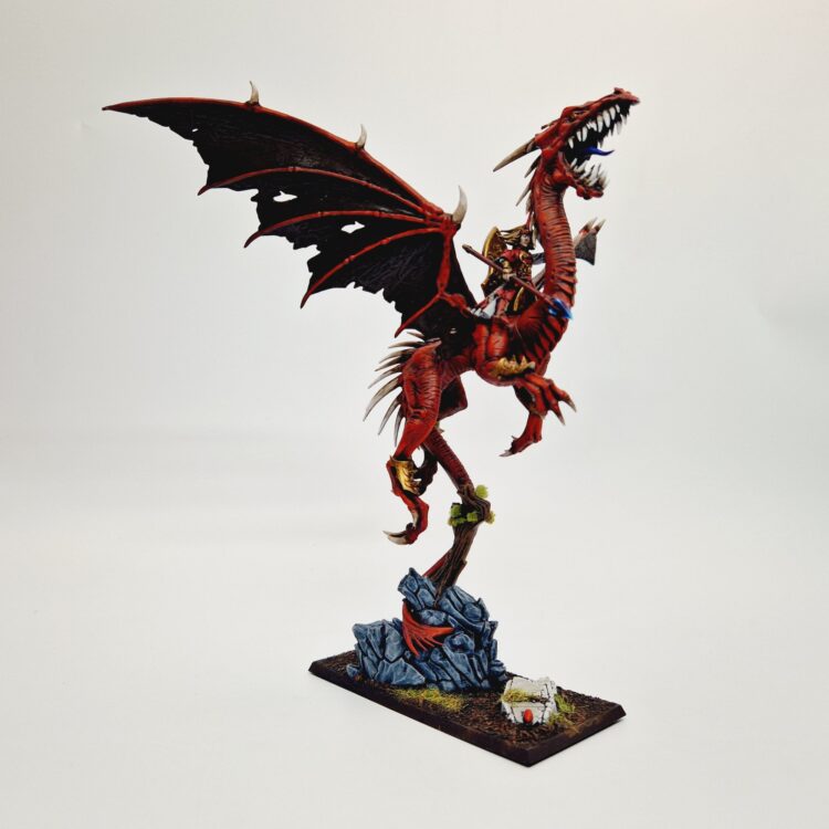 A photo of a High Elf Mage on Dragon Warhammer miniature