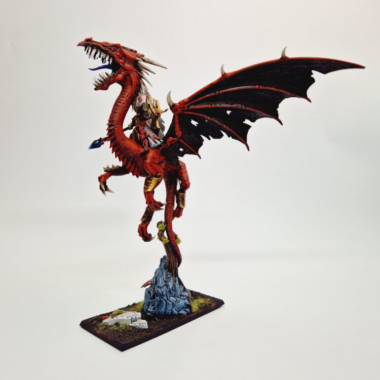 A photo of a High Elf Mage on Dragon Warhammer miniature