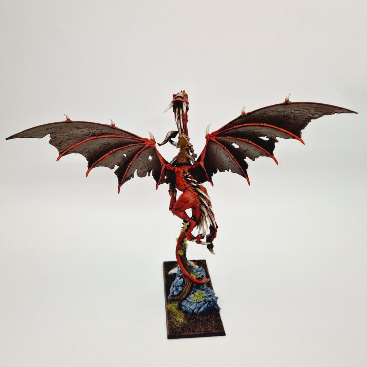 A photo of a High Elf Mage on Dragon Warhammer miniature