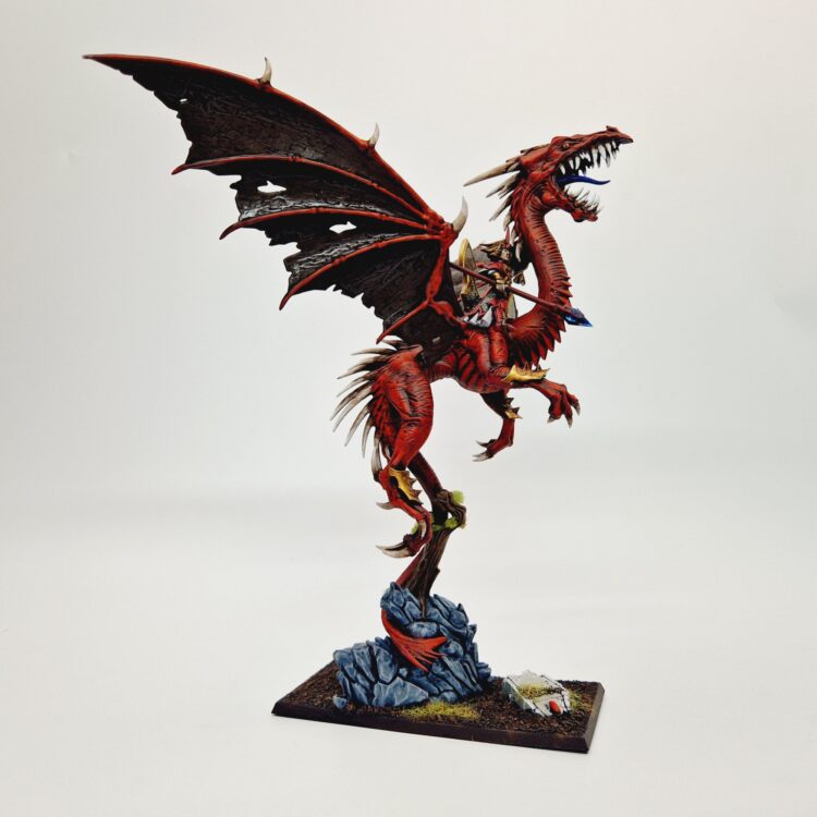 A photo of a High Elf Mage on Dragon Warhammer miniature