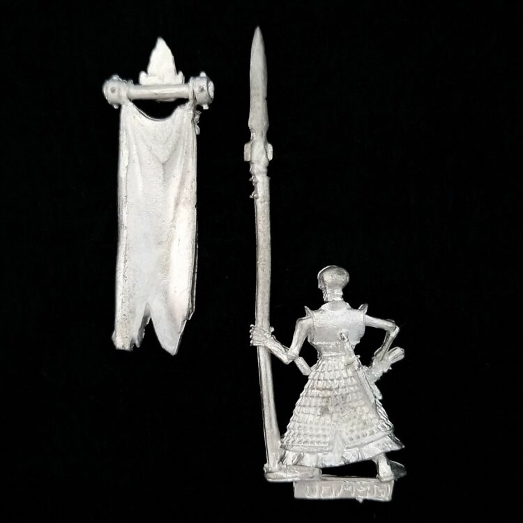 A photo of a Dogs of War Cursed Company Standard Bearer Warhammer miniature