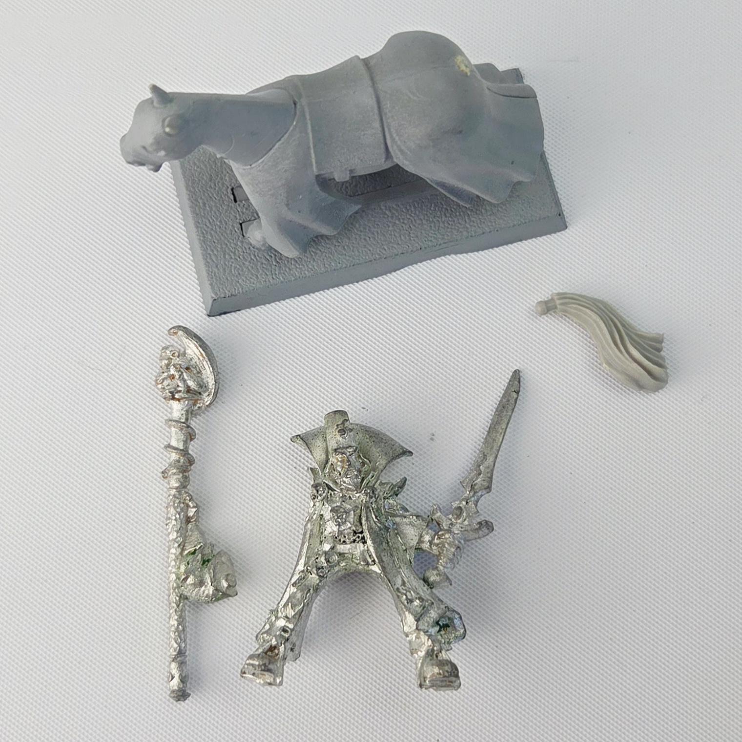 A photo of a The Empire Mounted Gold Wizard Warhammer miniature