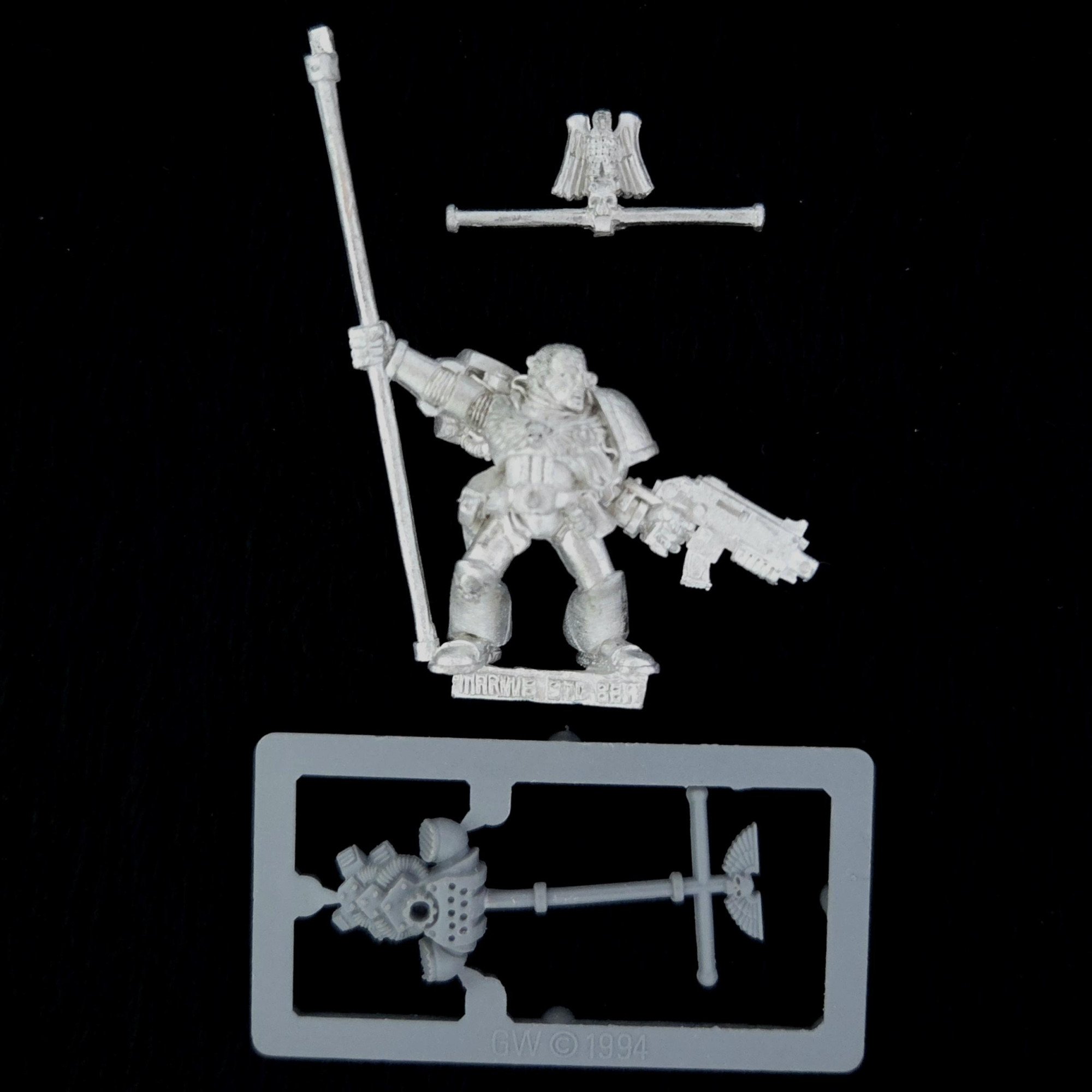 A photo of a Space Marines Company Standard Bearer Warhammer miniature