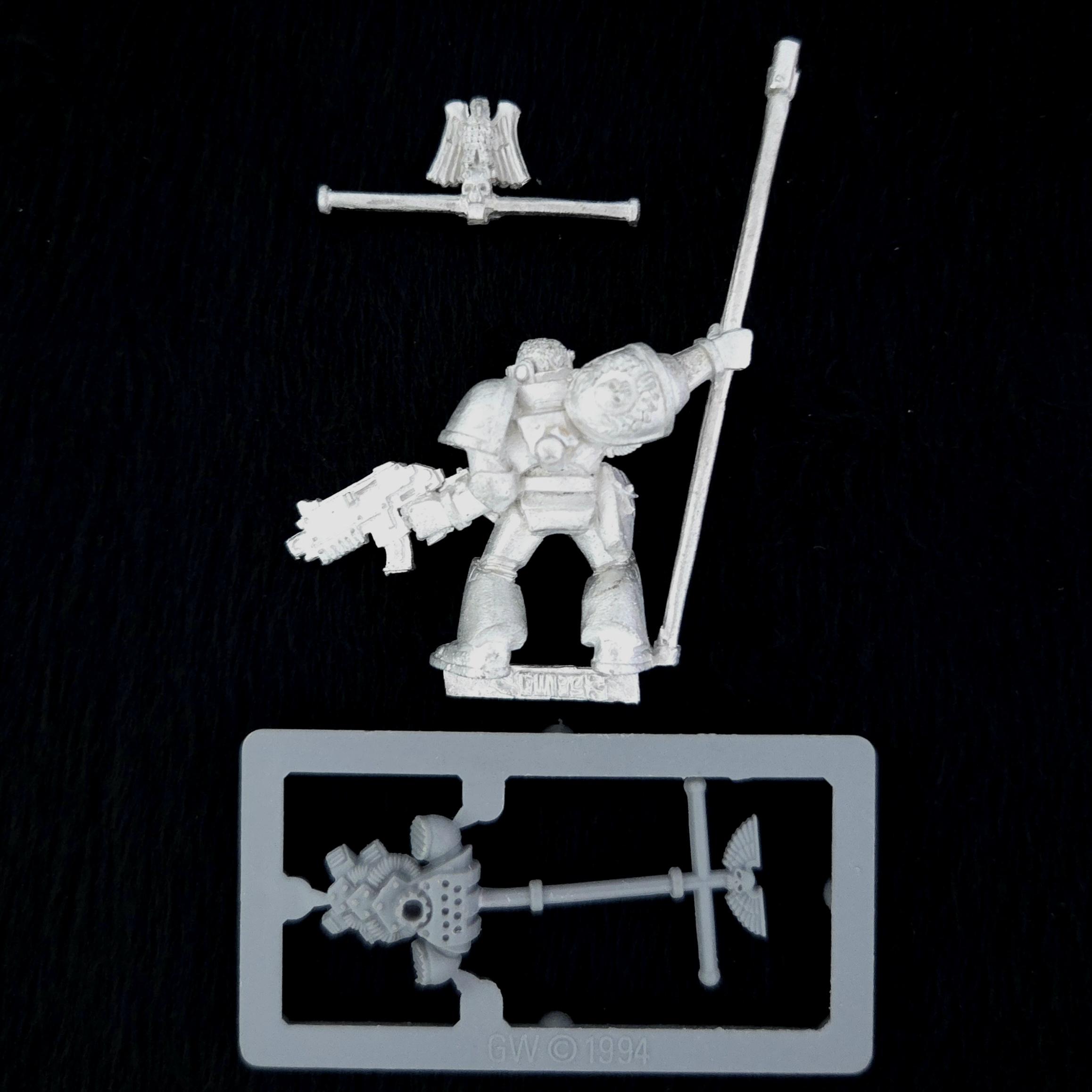 A photo of a Space Marines Company Standard Bearer Warhammer miniature